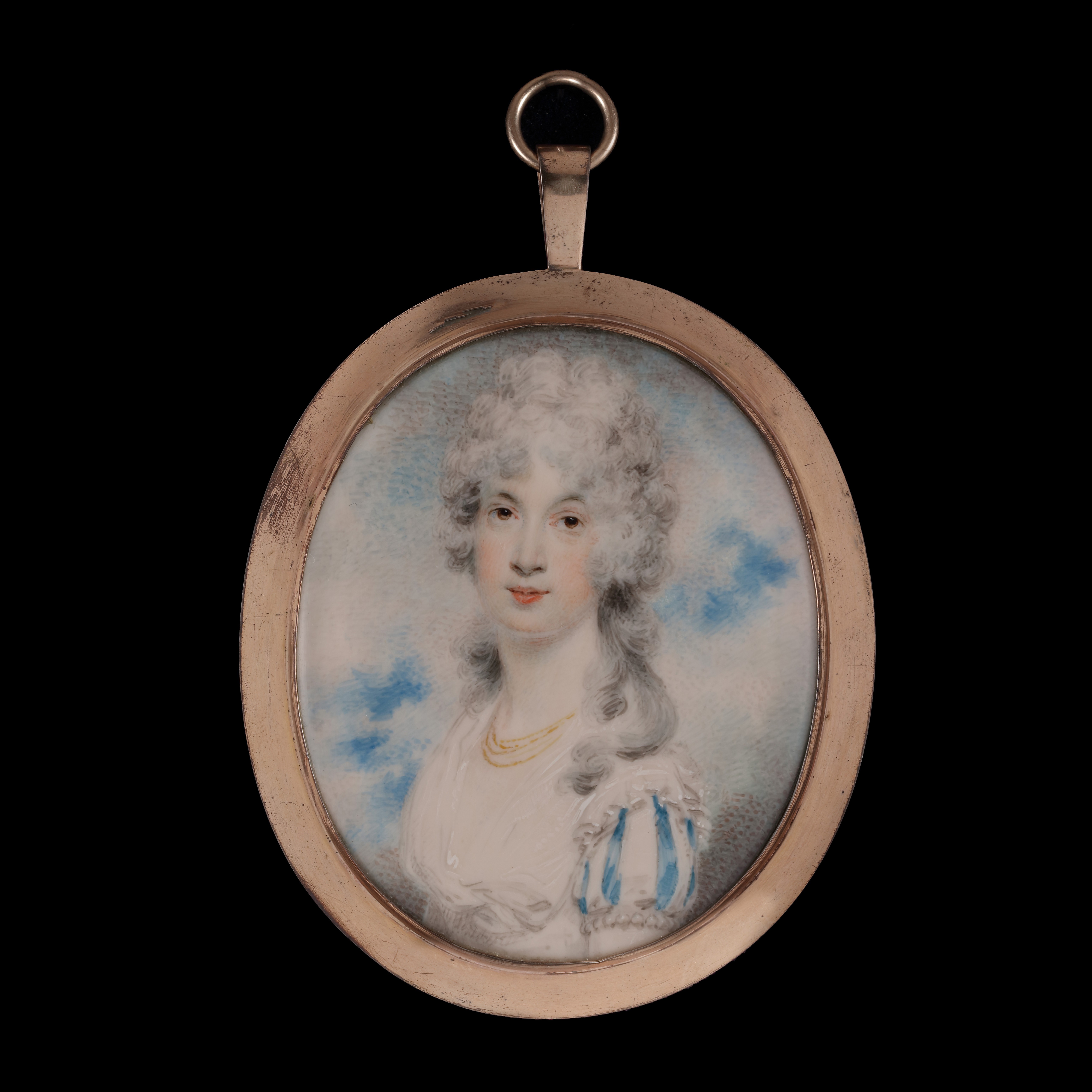 Portrait miniature of a Lady, possibly Mrs Bardsley, wearing a white dress, with white and blue striped sleeves, her hair worn up and powdered, with a gold necklace